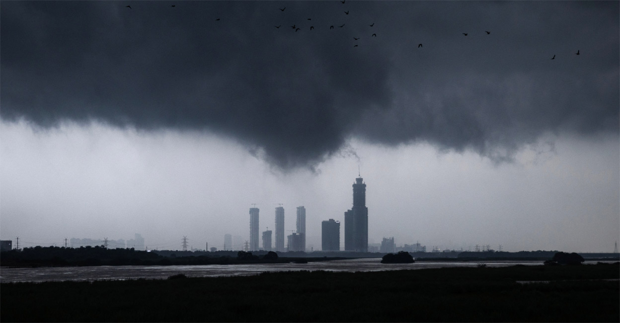Monsoon clouds loom over the overflowing river Yamuna, in New Delhi in July. Photo: Reuters/Adnan Abidi/File