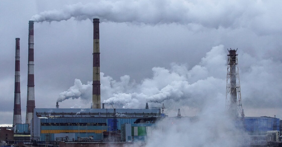 A view through a bus window shows Nadezhda Metallurgical Plant of Nornickel company in Russia. Photo: Reuters/Tatyana Makeyeva/File