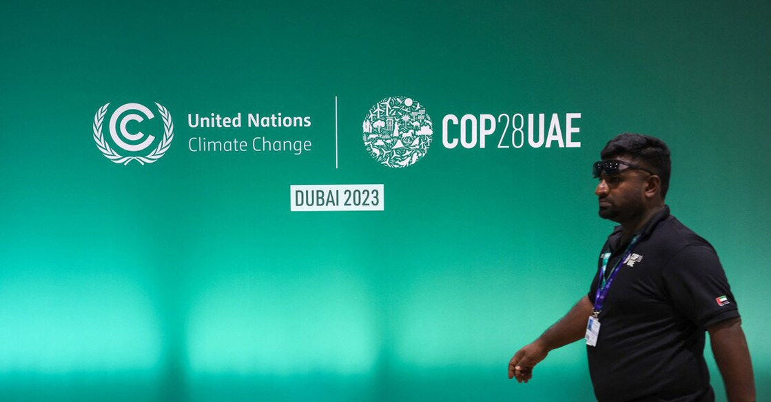 A man walks past a COP28 logo ahead of the United Nations climate summit in Dubai. Photo: Giuseppe CACACE/AFP