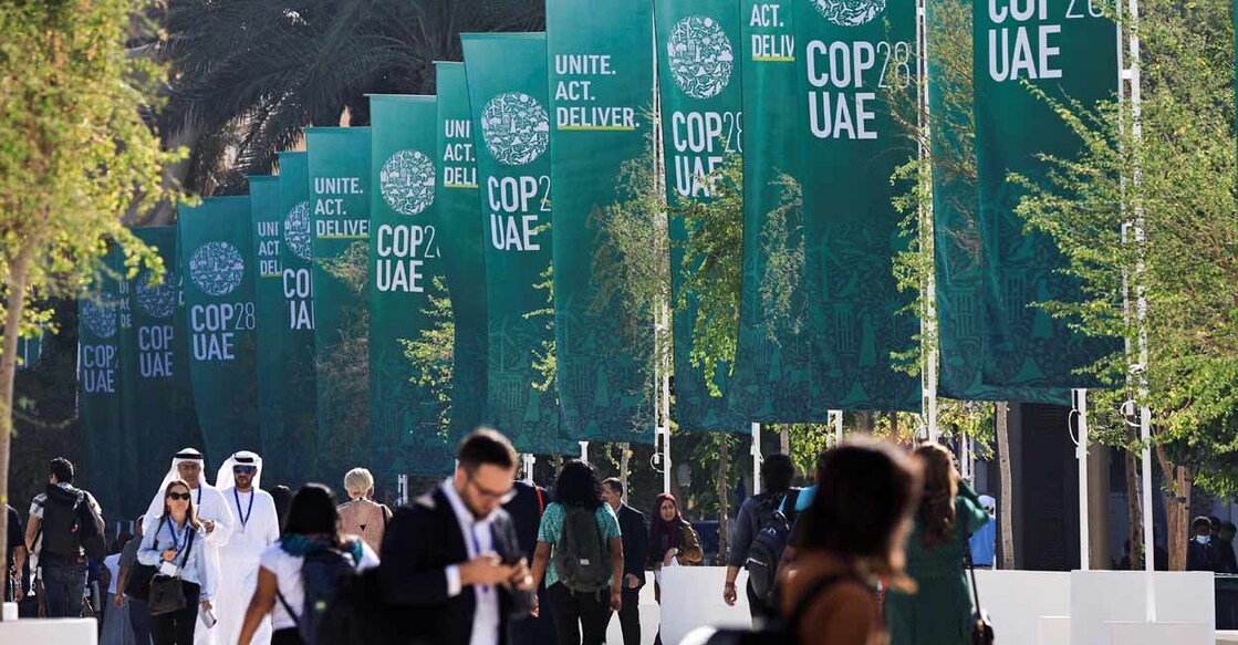 CLIMATE-UN Delegates walk at the United Nations Climate Change Conference COP28 in Dubai. Photo: Reuters/Thaier Al Sudani/File