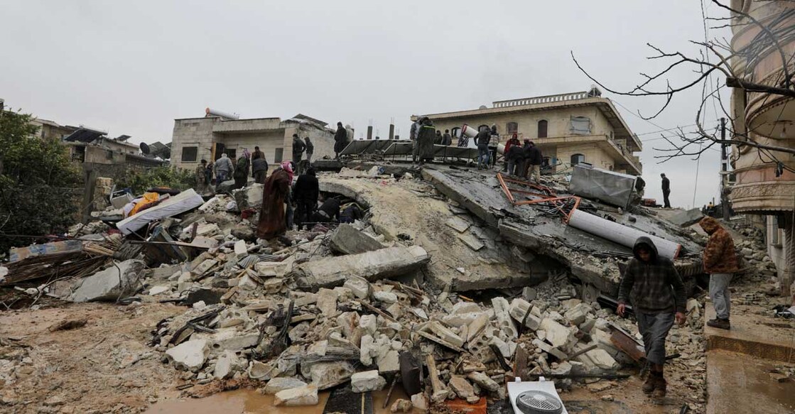 People gather as rescuers search for survivors under the rubble after the earthquake in Jandaris, Syria. Photo: Reuters/Khalil Ashawi