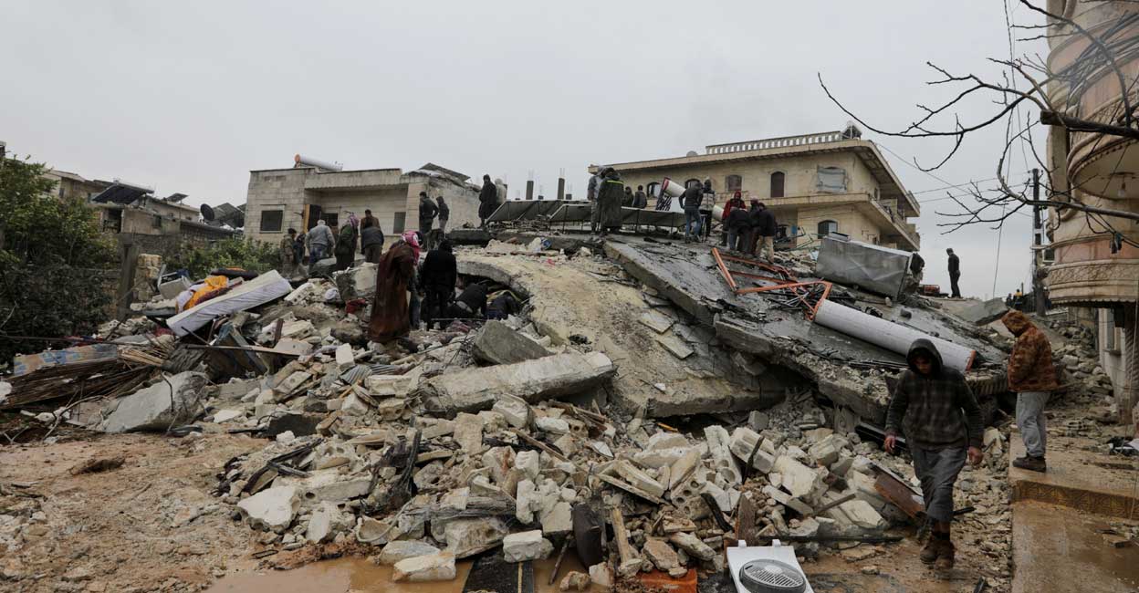 People gather as rescuers search for survivors under the rubble after the earthquake in Jandaris, Syria. Photo: Reuters/Khalil Ashawi