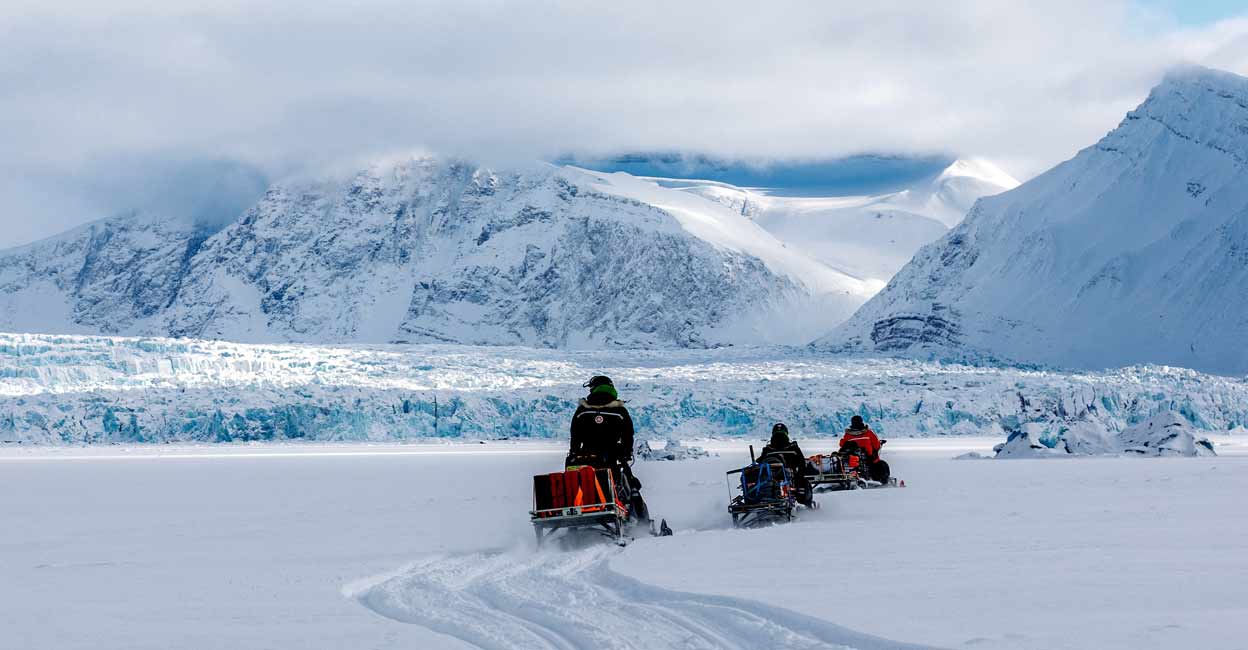 Scientists ride their snowmobiles near Kronebreen glacier through the arctic landscape near Ny-Alesund, Svalbard, Norway. File photo: Lisi Niesner/Reuters