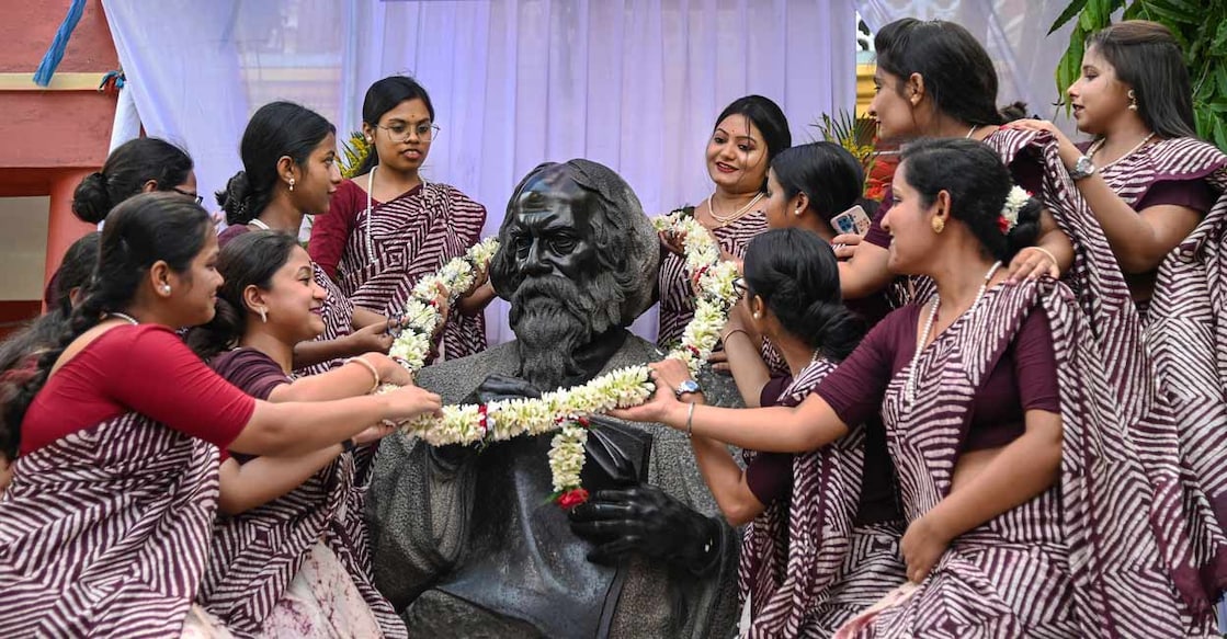 PTI05_08_2023_000138B Students of Rabindra Bharati University garland a statue of Nobel laureate poet Rabindranath Tagore on the eve of his birth anniversary, at his ancestral house 'Jorasanko Thakurbari', in Kolkata on Monday. Photo: PTI Photo