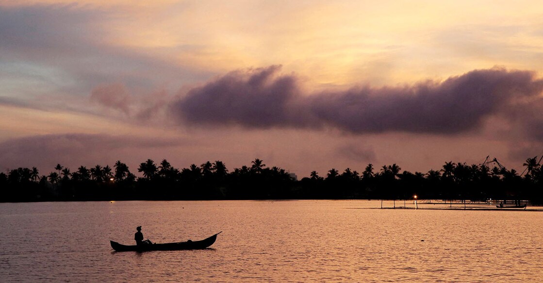 A man rows his boat in the tributary waters of Vembanad Lake against the backdrop of pre-monsoon clouds on the outskirts of Kochi. Reuters/Sivaram V/File Photo