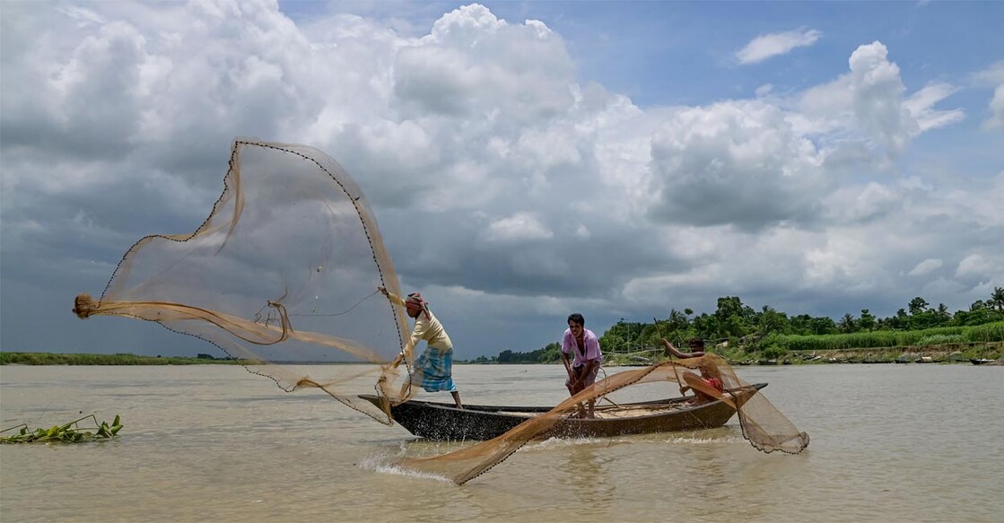 Fishermen cast their fishing nets in the Hooghly river, in Nadia. Image used for representational purpose. PTI Photo