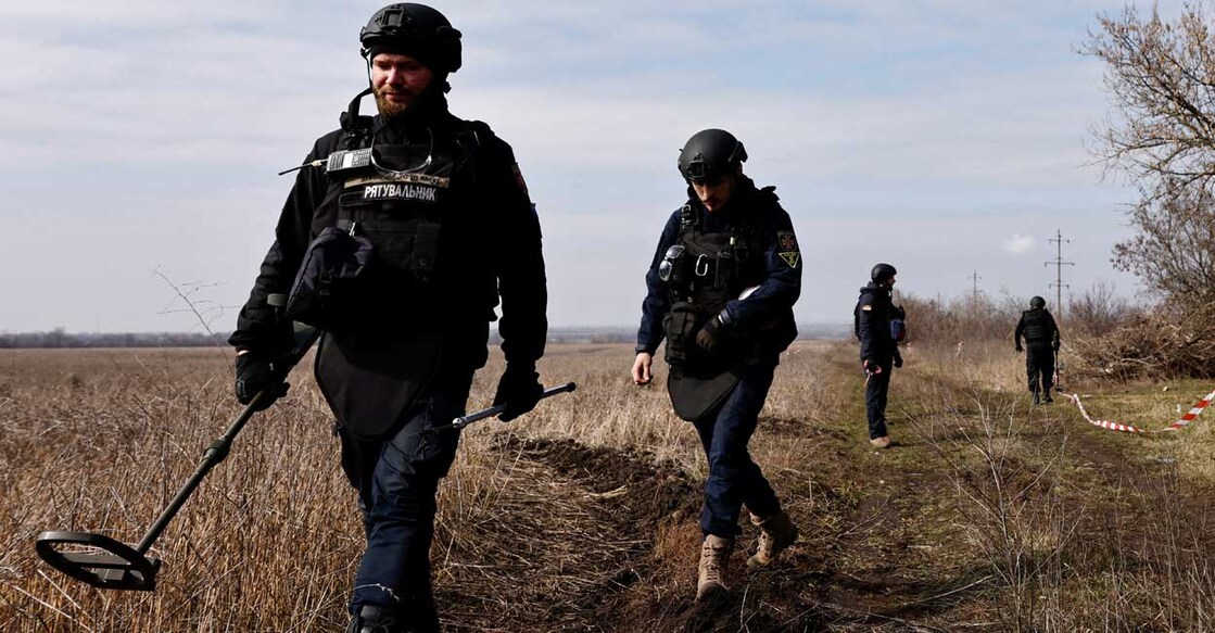Members of the de-mining department of the Ukrainian Emergency Services survey an area of farmland and electric power lines for land mines and other unexploded ordnance. Photo/ Reuters/Violeta Santos Moura/File