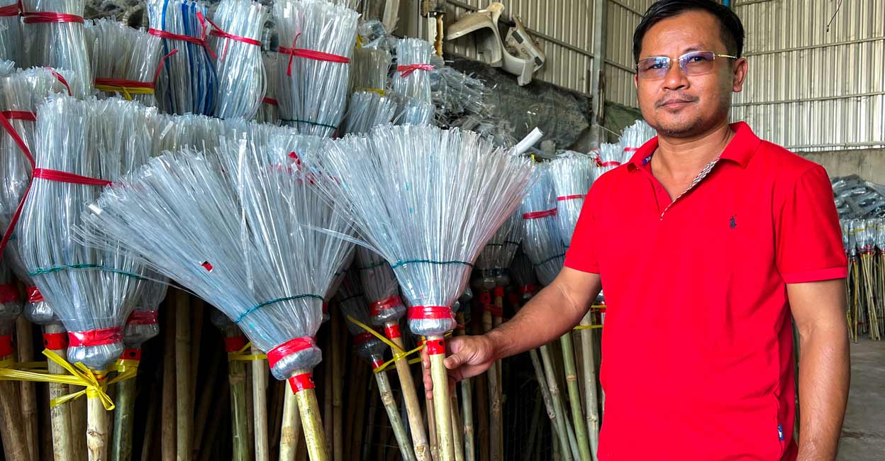 Has Kea poses next to plastic broomsticks at a warehouse in Phnom Penh. Photo: Reuters/Chantha Lach/File