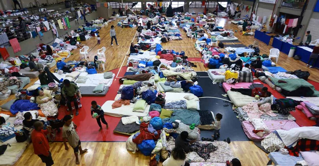 People who have been evacuated from flooded areas rest at a gym used as a shelter in Porto Alegre, Brazil. Photo: Reuters/Diego Vara/File