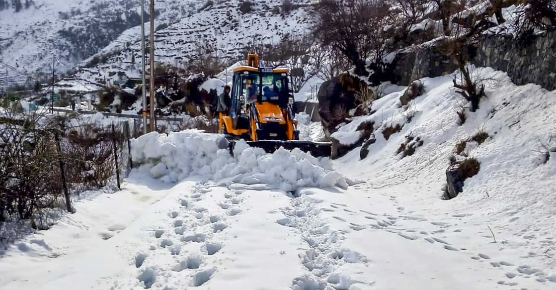 Snow being cleared from a road, in Uttarkashi district of Uttarakhand, Sunday. Photo: PTI