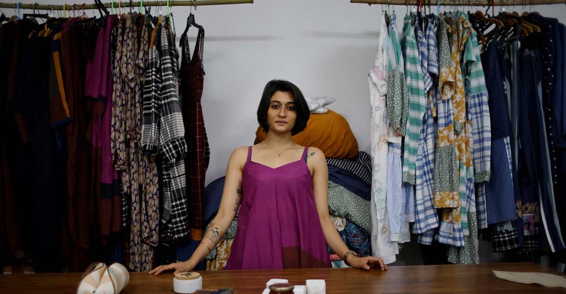 Kriti Tula, a fashion designer, poses for a picture as she stands next to the clothes made from discarded fabric waste, at her factory in New Delhi. REUTERS/Adnan Abidi