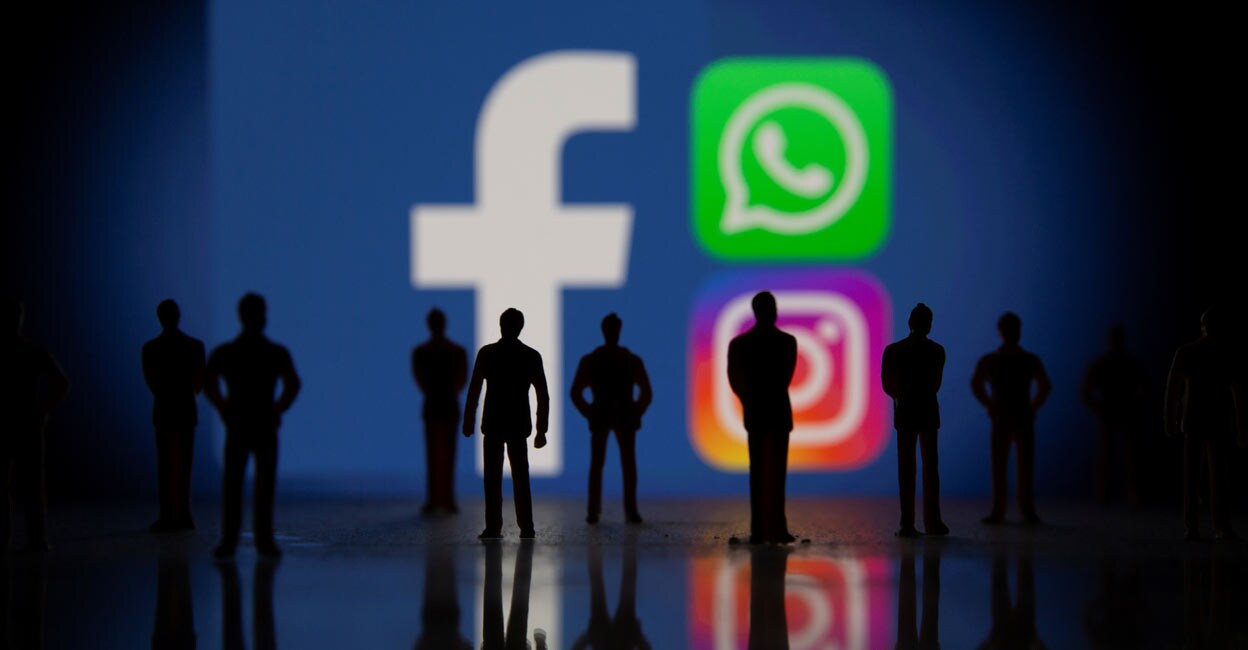 Small toy figures are seen in front of displayed Facebook, Whatsapp and Instagram logos in this illustration taken October 4, 2021. Reuters/Dado Ruvic/Illustration