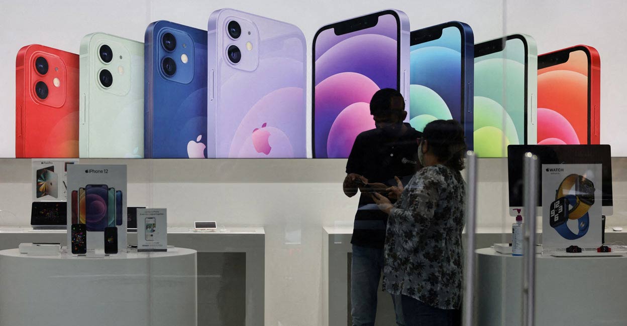 A salesperson speaks to a customer at an Apple reseller store in Mumbai. File Photo: Reuters/Francis Mascarenhas