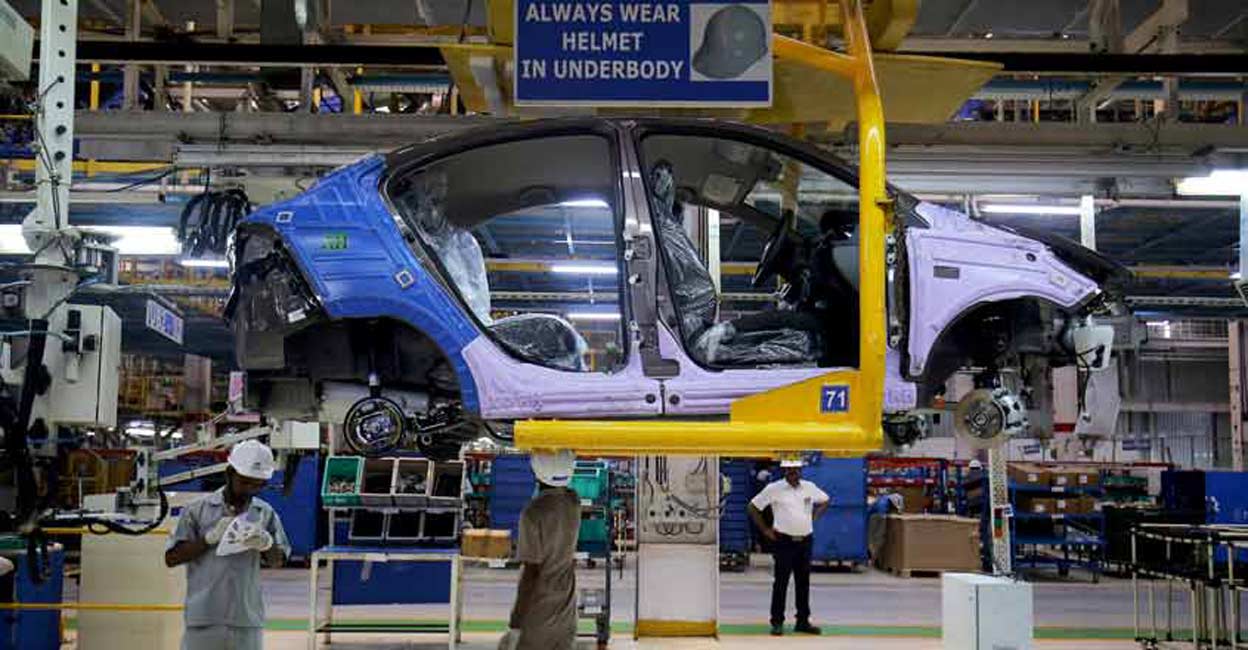 TATA-MOTORS-INDIA Workers assemble a Tata Tigor car inside the Tata Motors car plant in Sanand, on the outskirts of Ahmedabad. File Photo: Reuters/Amit Dave