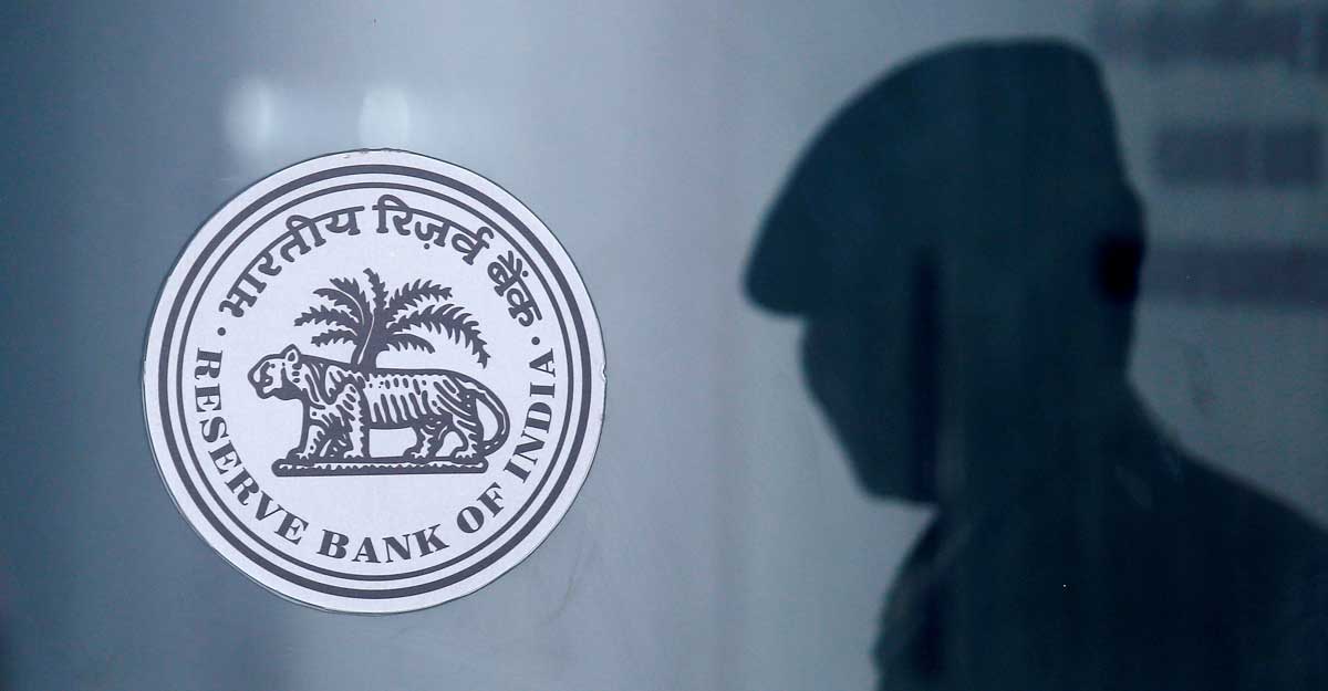 A security guard's reflection is seen next to the logo of the Reserve Bank Of India (RBI) at the RBI headquarters in Mumbai, India, June 6, 2019. Reuters/Francis Mascarenhas/File Photo