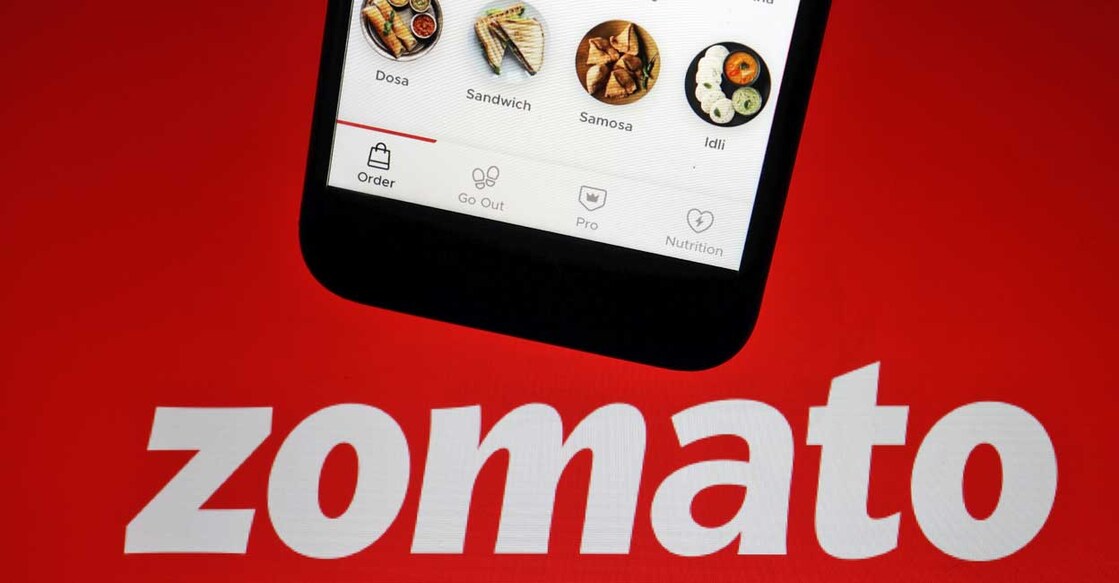 The app of Indian food delivery company Zomato is seen on a mobile phone above its logo displayed in this illustration picture taken July 14, 2021. Reuters/Florence Lo/Illustration/File photo