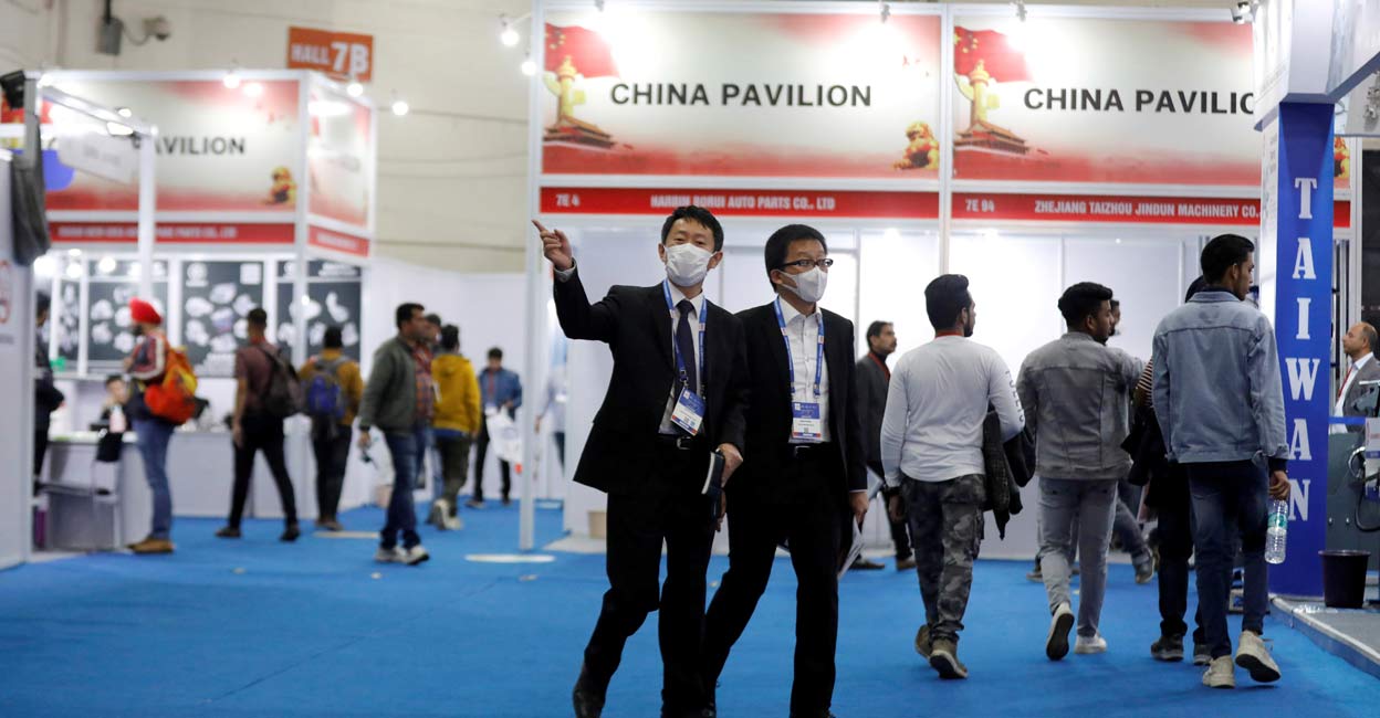 People wearing mask are seen near the stalls inside the China pavilion at the Auto Expo 2020. People wearing mask are seen near the stalls inside the China pavilion at the Auto Expo 2020.