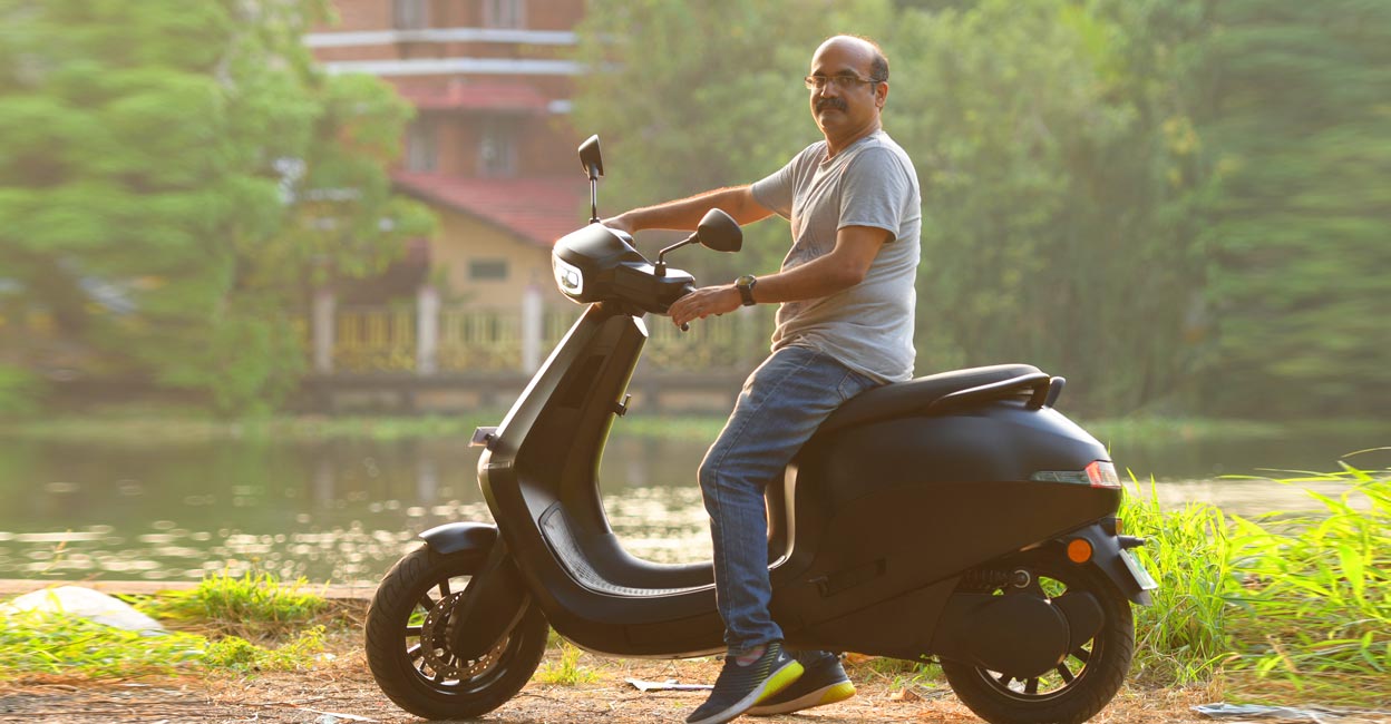 stagan-ola Stajen with his Ola scooter