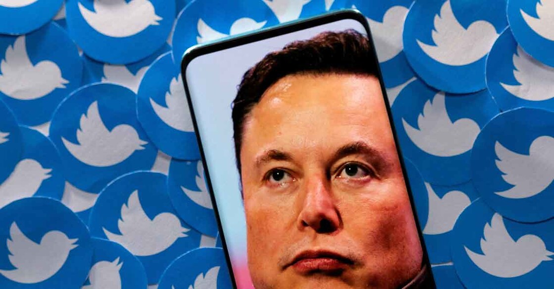 An image of Elon Musk is seen on a smartphone placed on printed Twitter logos in this picture illustration taken April 28, 2022. Photo: Reuters/Dado Ruvic/Illustration