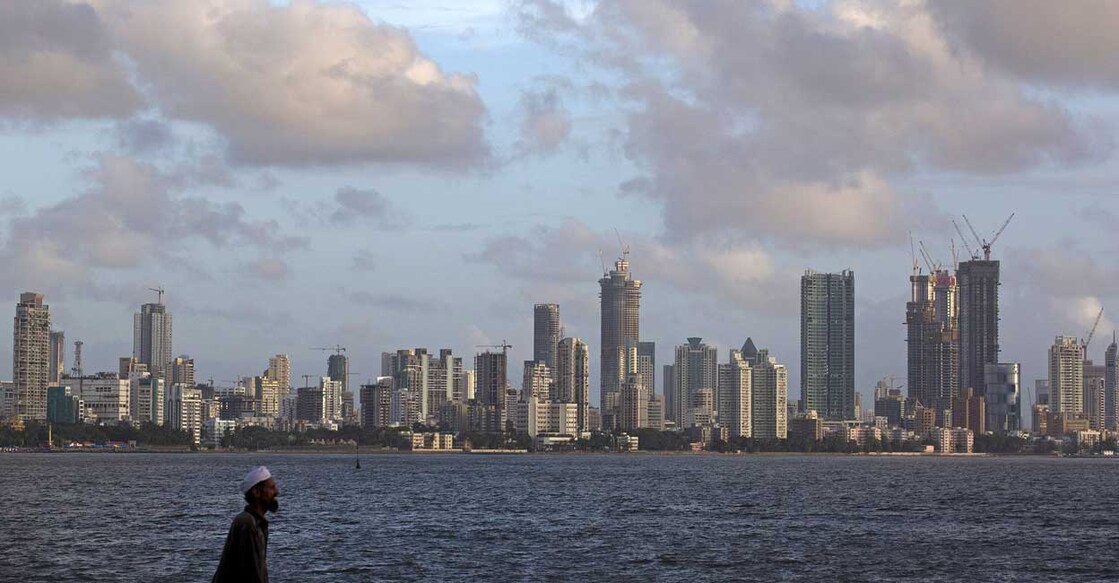 A man walks at the seafront as scattered clouds are seen over Mumbai's skyline, India, June 10, 2015. Photo: Danish Siddiqui/Reuters