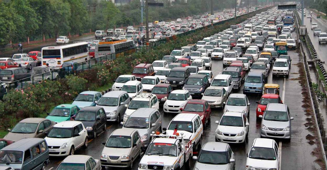 Heavy traffic moves along a busy road as it rains during a power-cut at the toll-gates at Gurgaon on the outskirts of New Delhi. File Photo: Reuters