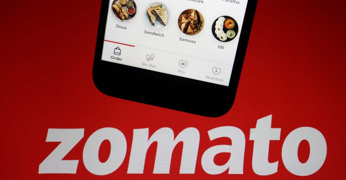The app of Indian food delivery company Zomato is seen on a mobile phone above its logo displayed in this illustration picture taken July 14, 2021. Photo: Reuters/Florence Lo/Illustration