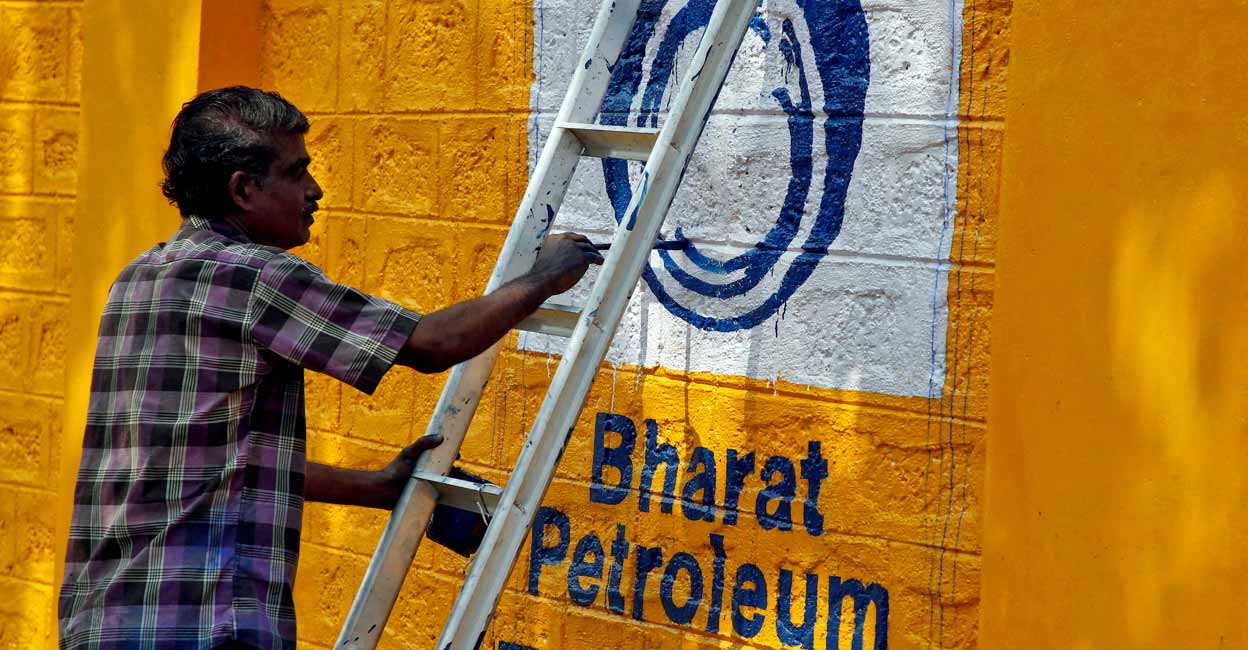  A man paints the logo of oil refiner Bharat Petroleum Corp (BPCL) on a wall on the outskirts of Kochi. File Photo: Reuters/Sivaram V