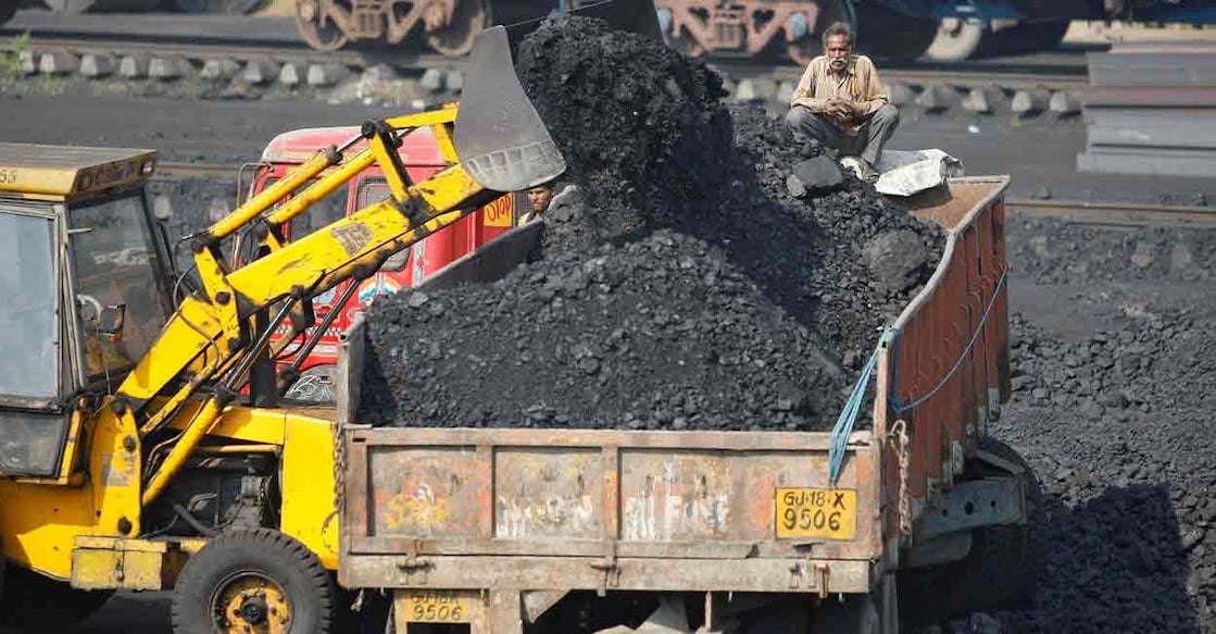 INDIA-POWER-COAL-IMPORTS FILE PHOTO: worker sits on a truck being loaded with coal at a railway coal yard on the outskirts of the western Indian city of Ahmedabad November 25, 2013. REUTERS/Amit Dav
