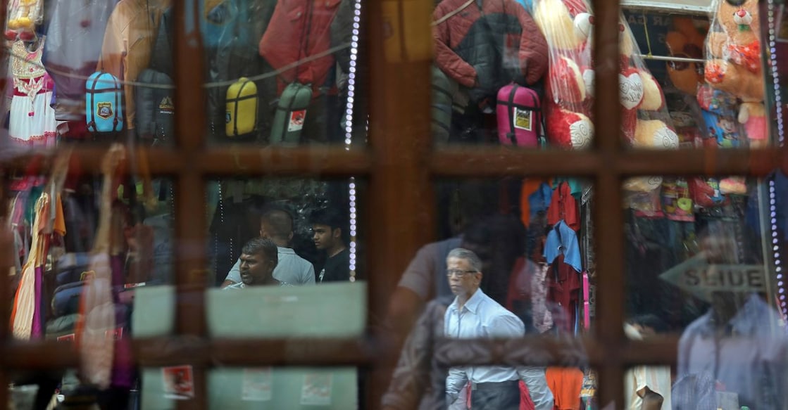 rbi-inflation People are reflected in a glass window of a shop at a marketplace in New Delhi, India, October 10, 2018. FILE PHOTO: Reuters