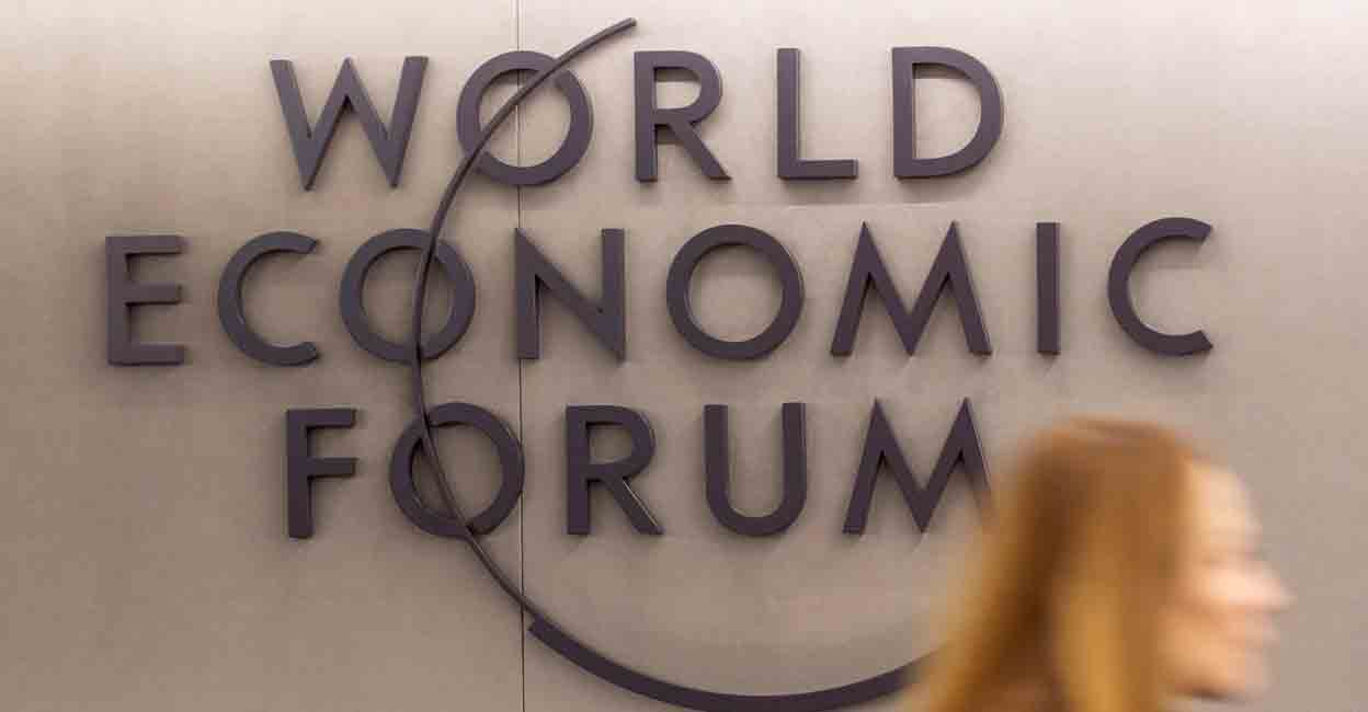WEF A woman walks past the logo of the World Economic Forum (WEF) 2023 at Davos Congress Centre in the Alpine resort of Davos, Switzerland, January 15, 2023. REUTERS/Arnd Wiegmann
