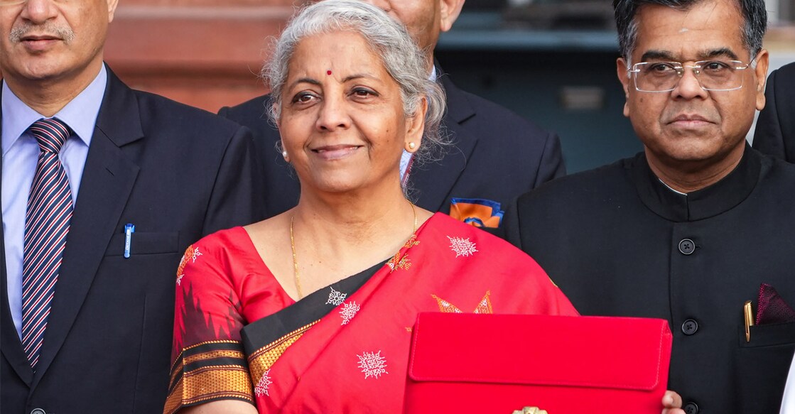 Union Finance Minister Nirmala carrying a folder-case poses for photographs outside the Finance Ministry at North Block in New Delhi, ahead of the presentation of the Union Budget 2023-24. Photo: PTI