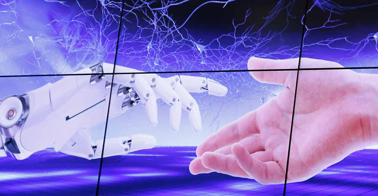 An illustration projected on a screen shows a robot hand and a human one moving towards each others during the "AI for Good" Global Summit at the International Telecommunication Union (ITU) in Geneva, Switzerland on June 7, 2017. File photo: Reuters/ Denis Balibouse