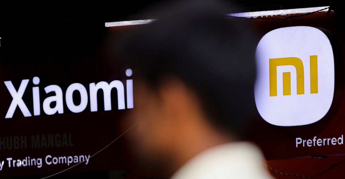 A man walks past a logo of Xiaomi, a Chinese manufacturer of consumer electronics, outside a shop in Mumbai on May 11, 2022. File photo: Reuters/Francis Mascarenhas