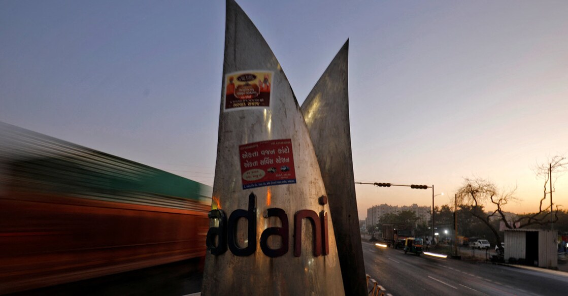 Traffic moves past the logo of the Adani Group installed at a roundabout on the ring road in Ahmedabad, India, February 2, 2023. REUTERS/Amit Dave/File Photo