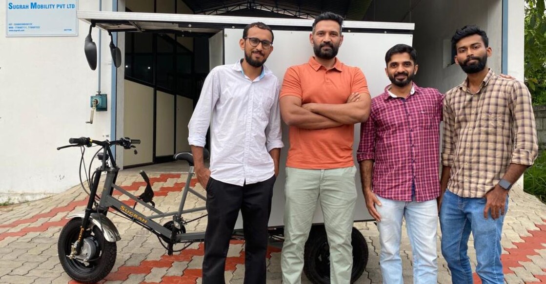 (From left) Sugrah Mobility co-founders Azim Hashmi, Davis Jacob, Jacob Thekkekara and Abdul Hadi Mutheri with their latest vehicle ready for delivery. Photo: Onmanorama