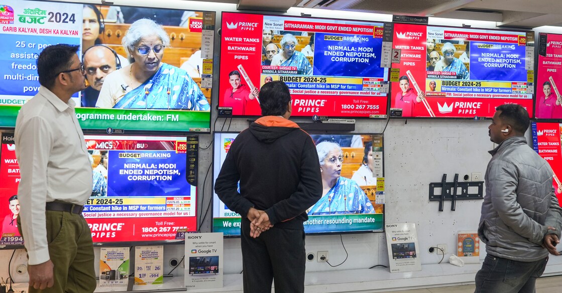 People watch Union Finance Minister Nirmala Sitharaman presenting the Interim Budget 2024 in Parliament, at a television showroom in Kolkata. Photo: PTI