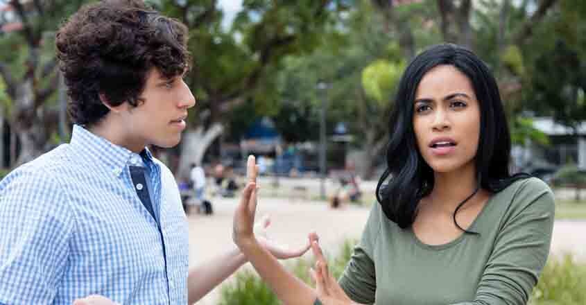 Beautiful latin woman rejecting man outdoors in the city