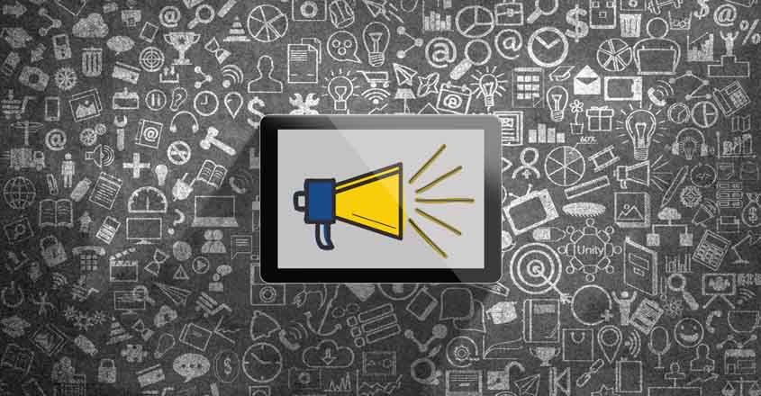 Megaphone icon on digital tablet in front of chalkboard