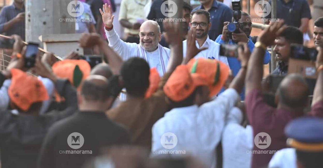 Union Home Minister Amit Shah greets BJP supporters as he arrived for a party event in Thrissur on Sunday. Photo: Vishnu V Nair/Manorama