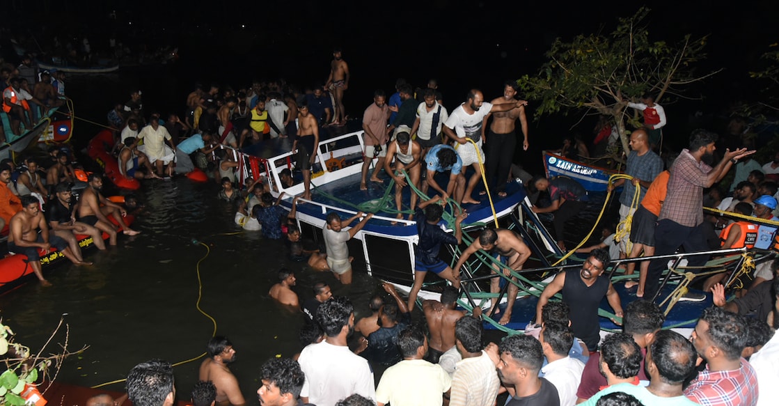 Local fishermen and volunteers drag the ill-fated boat ashore at Thooval Theeram in Tanur, Malappuram. Photo: PRD