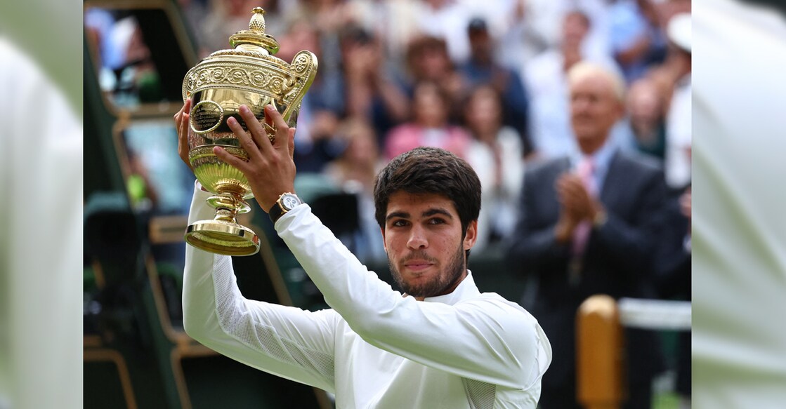 alcaraz-triumph-wimbledon-trophy Spain's Carlos Alcaraz celebrates with the trophy after winning the Wimbledon final against Serbia's Novak Djokovic. Photo: Reuters/Toby Melville