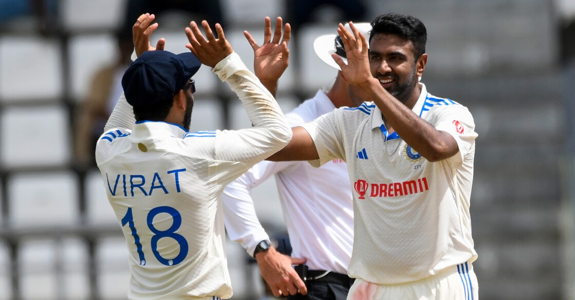 Ravichandran Ashwin (right) and Virat Kohli of India celebrate the dismissal of Alzarri Joseph of West Indies during day one of the First Test at Windsor Park in Roseau, Dominica on Wednesday. Photo: AFP/Randy Brooks 