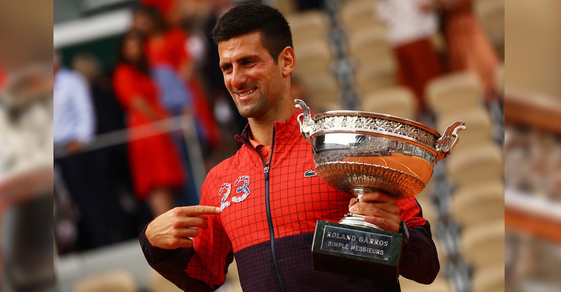 Serbia's Novak Djokovic poses with the trophy after winning the French Open and his 23rd Grand Slam as seen on his jacket. Photo: Reuters/Kai Pfaffenbach