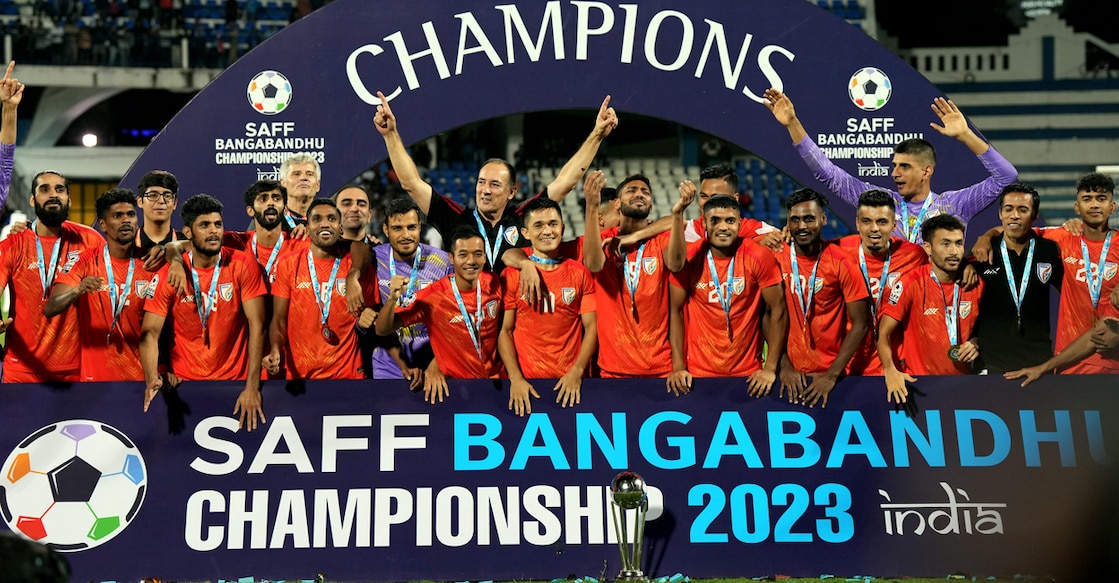 Indian football team players and staff celebrate with the SAFF Championship 2023 trophy after winning the final against Kuwait at Sree Kanteerava Stadium in Bengaluru on Tuesday. Photo: PTI