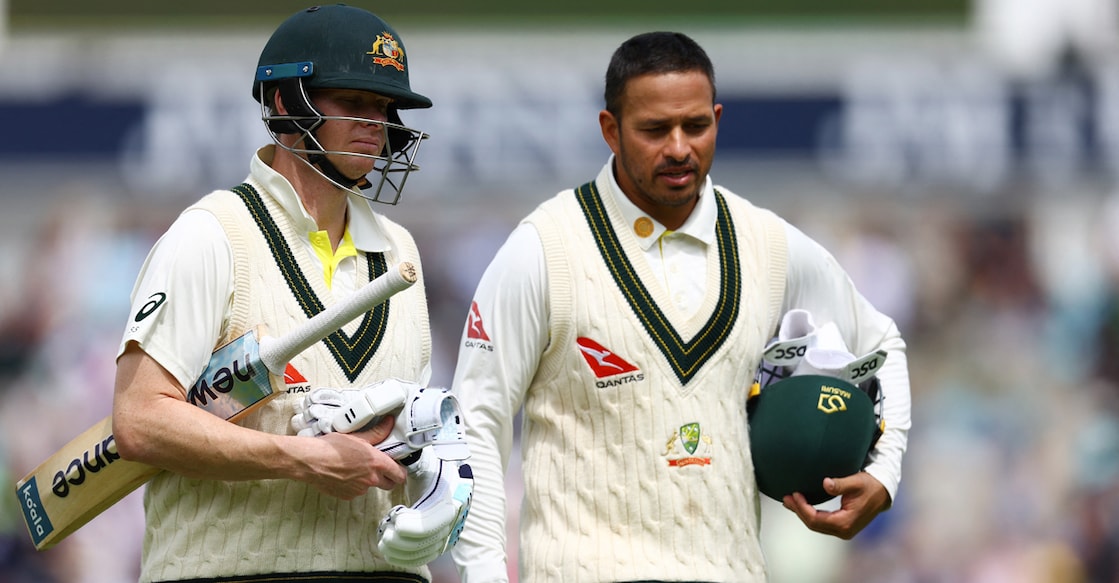 Australia's Steve Smith and Usman Khawaja walk off for lunch. Photo: Reuters/Paul Childs