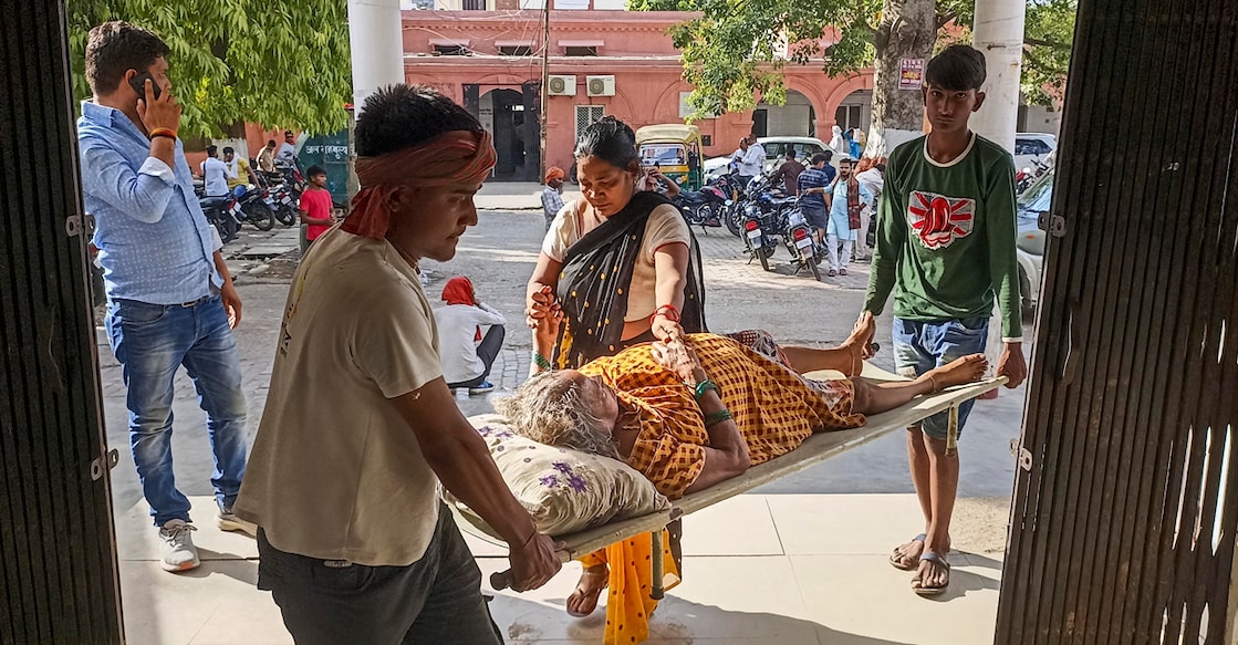 Family members bring their patient to a hospital during heatwave conditions, in Ballia, Uttar Pradesh on Sunday. Photo: PTI