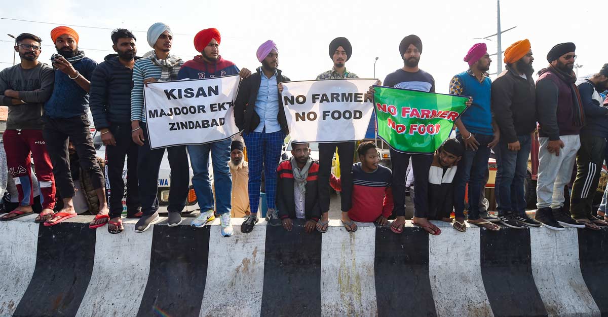 Farmers start day-long 'relay' hunger strike Farmers hold placards during their sit-in protest against the Centre's farm reform laws, at Delhi-UP border in Ghaziabad, Sunday, Dec. 20, 2020. (PTI Photo/Manvender Vashist)