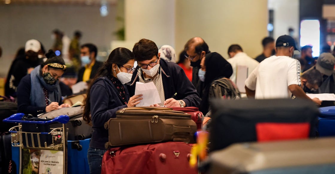 Passengers wait in the arrival area after landing of a flight from United Kingdom at the Chhatrapati Shivaji Maharaj International Airport, in Mumbai, Tuesday, Dec. 22, 2020. New restrictions were put in place by authorities from 12:00 am for UK flights in the light of the new Covid-19 strain found in the country, which is said to be a super spreader and is claimed to be 70% more transmissible. Indian government has temporarily suspended all passengers' flights from the United Kingdom. (PTI Photo/Kunal Patil)