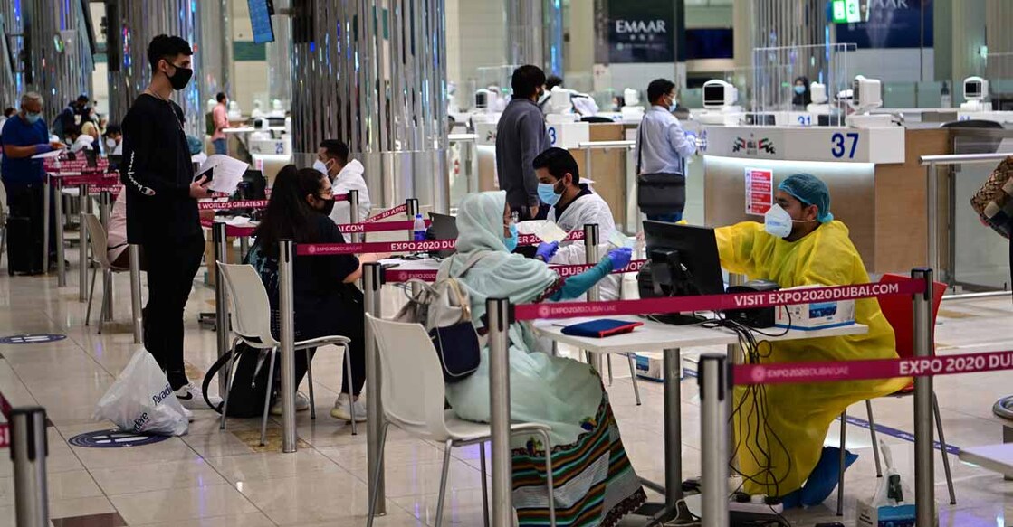 Tourists get a medical screening upon arrival at Teminal 3 at Dubai airport, in the United Arab Emirates, on July 8, 2020, as the Gulf emirate reopens to tourists after a long shutdown due to the COVID-19 pandemic. (Photo by GIUSEPPE CACACE / AFP)