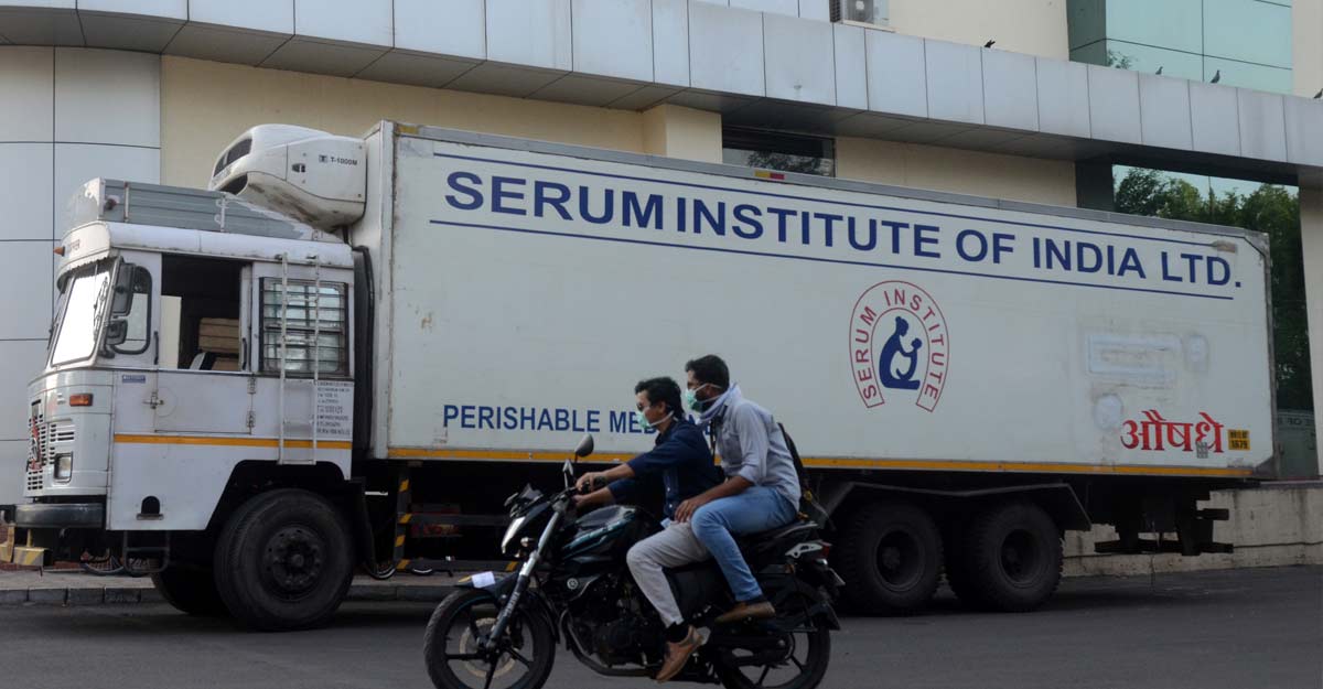 India's Serum Institute expects approval for emergency use of Oxford vaccine in days Men ride on a motorbike past a supply truck of India's Serum Institute, the world's largest maker of vaccines, which is working on a vaccine against the coronavirus disease (COVID-19) in Pune, India, May 18, 2020. File Photo: REUTERS/Euan Rocha